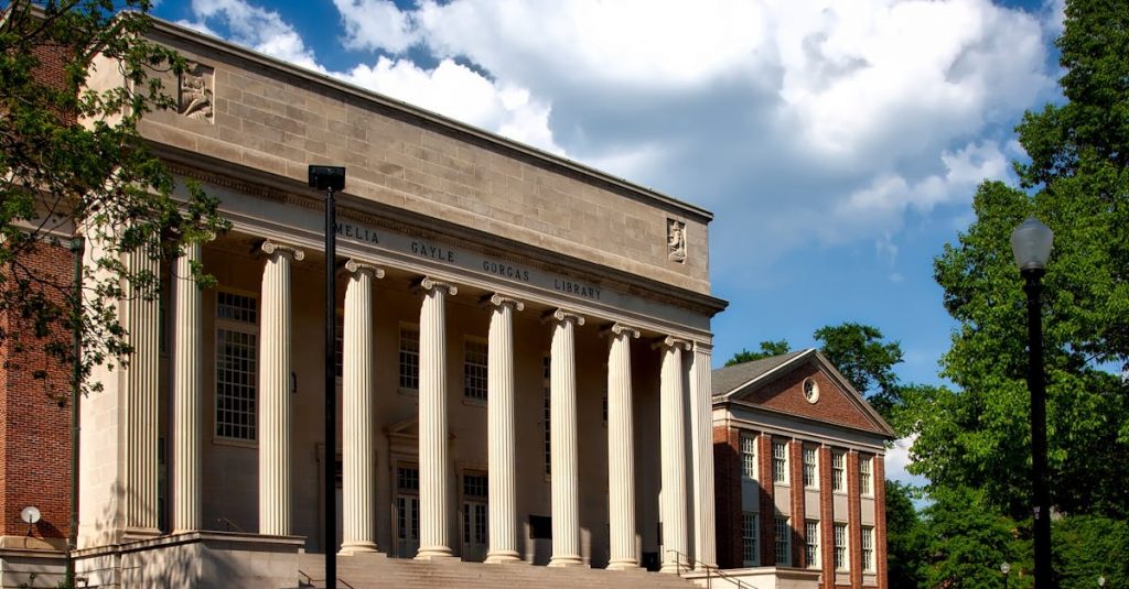 Historic neoclassical university library with columns on a sunny day.
