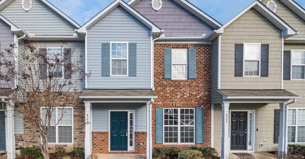 Elegant view of suburban townhouses showcasing diverse architectural styles.
